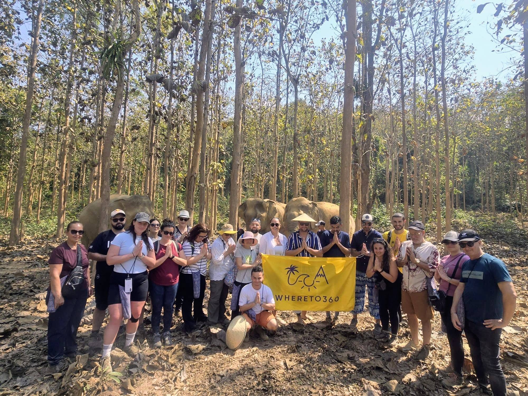 Whereto360 travellers with the Whereto360 flag during a group adventure